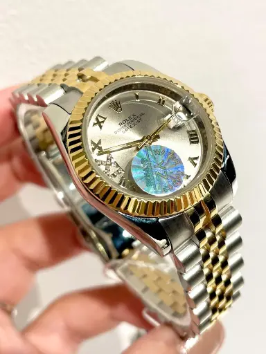 [Rolex Datejust, likely model featuring a silver-26]  Rolex Datejust, likely model featuring a silver-26